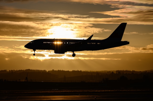 Airplane flying at sunset