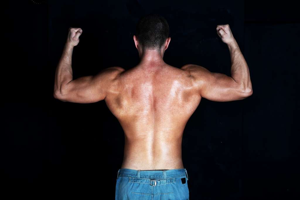 man flexing from the back