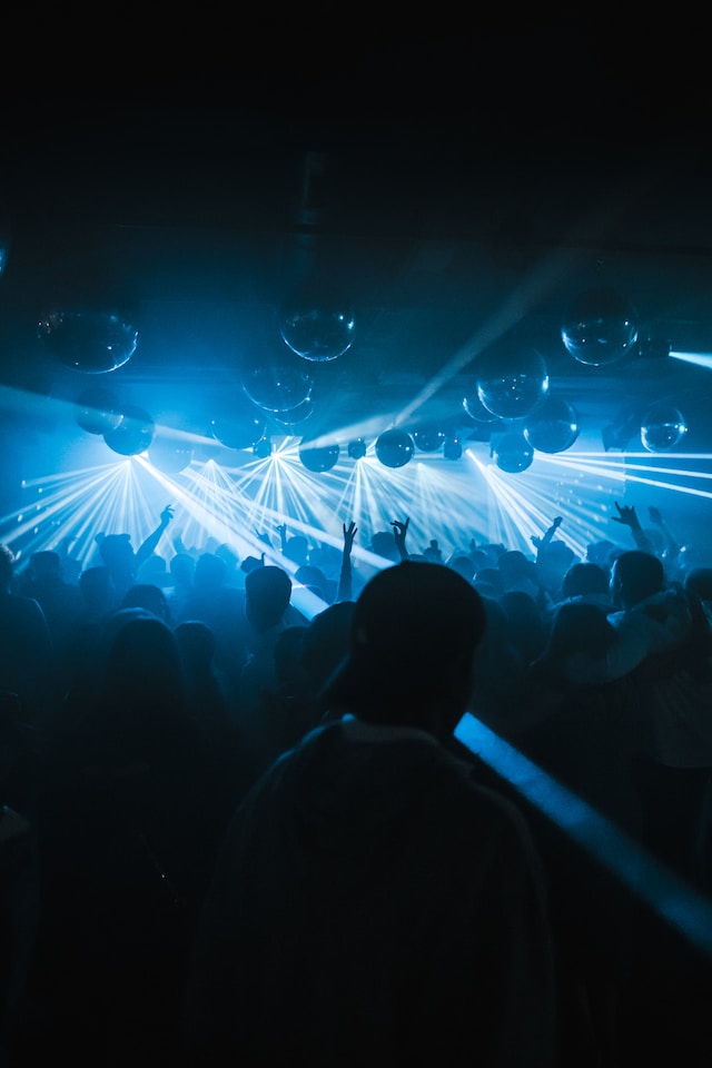 people dancing in a dark club