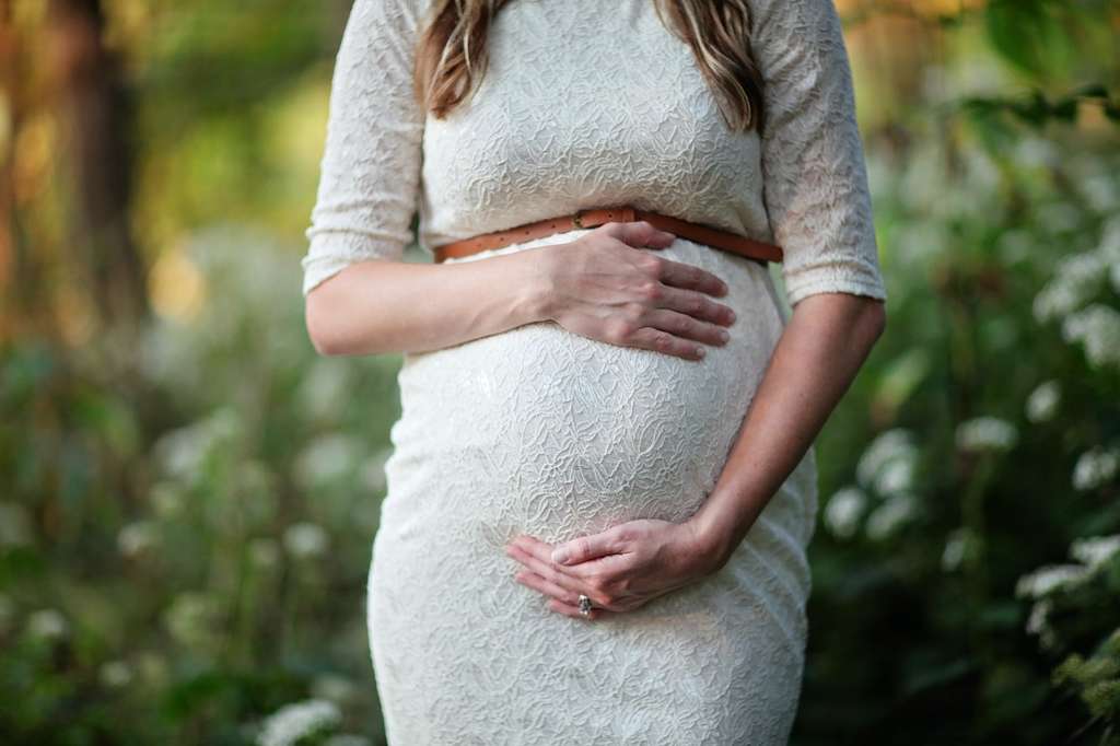 pregnant woman holding stomach