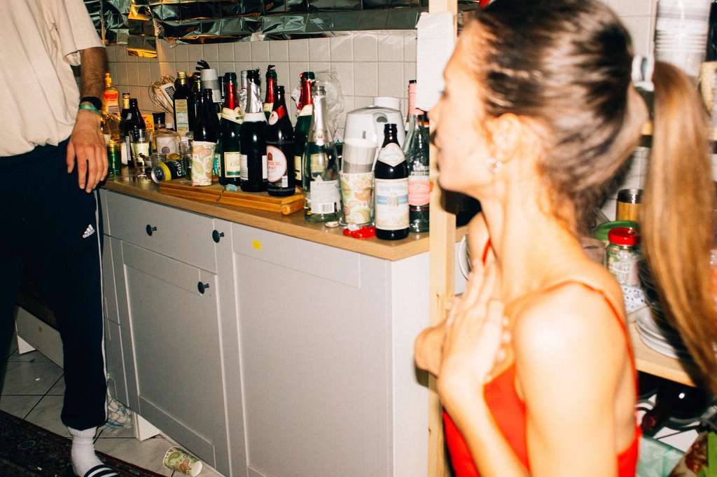 woman looking at bottles of alcohol on the counter