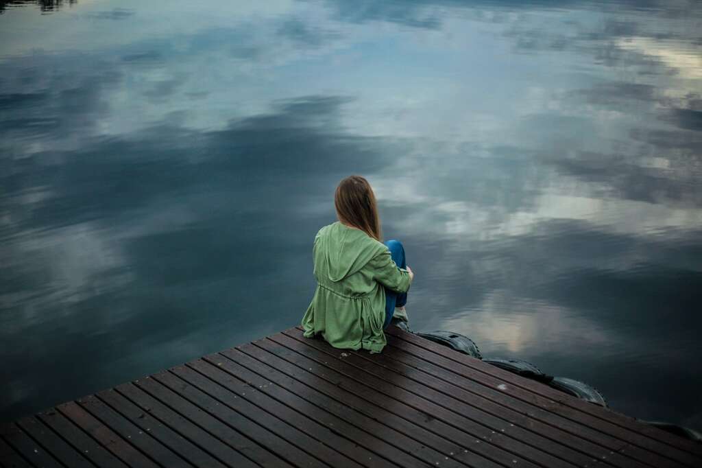 woman sitting on dock