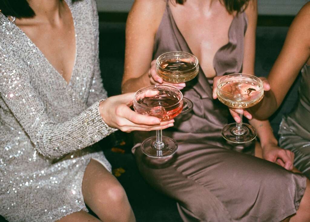 women holding cocktails