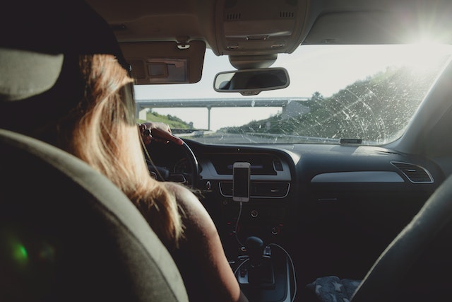Woman driving to conduct mobile drug testing services
