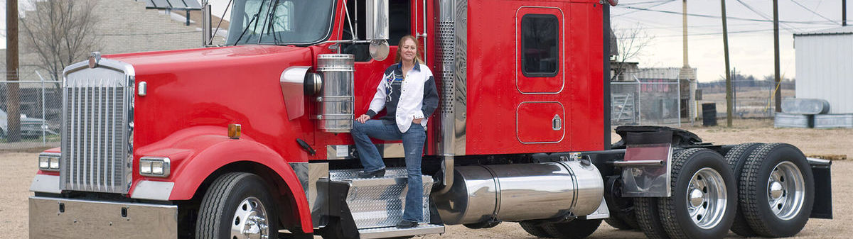 Woman standing in front of semi truck