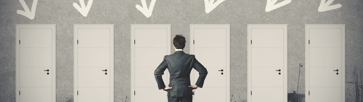 Man standing in front of 6 white doors