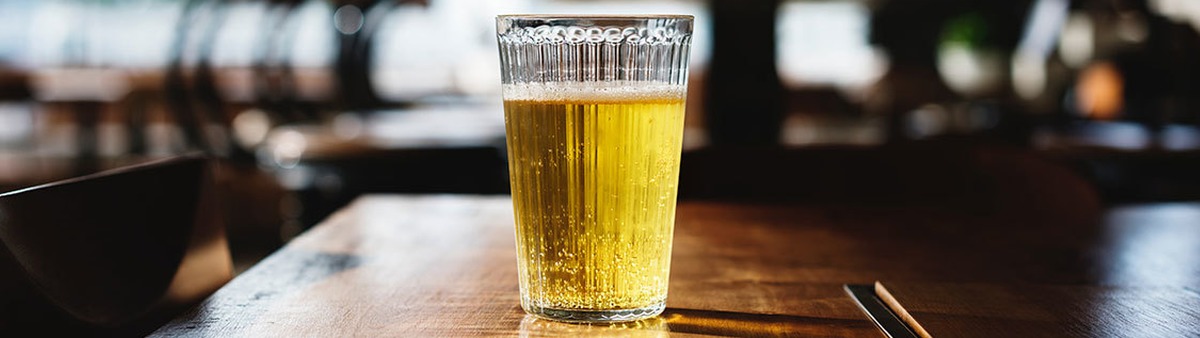 Full Glass of Beer on Bar