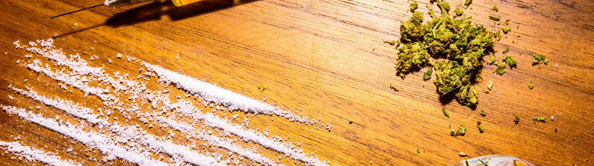 lines of cocaine, marijuana & a syringe
