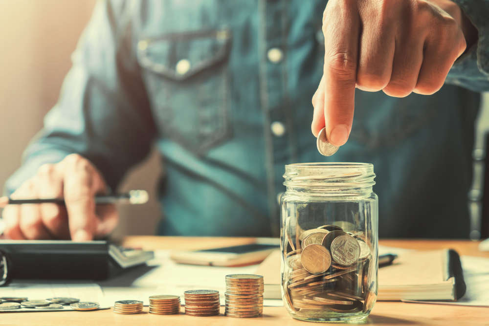 business man counting coins to save money