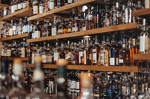 assorted alcohol bottles on shelves