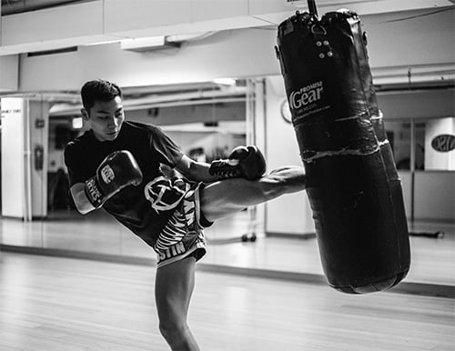 athlete kicking punching bag