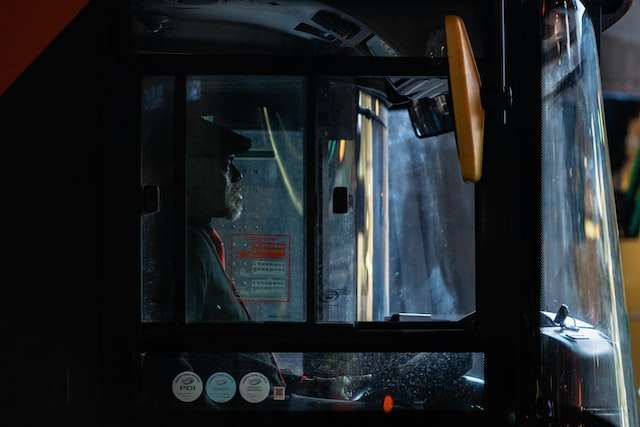 Side profile of a bus driver from outside the vehicle