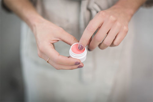 woman using pink balm