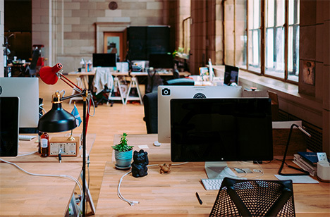 desks with laptops