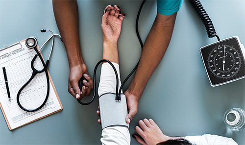 doctor taking patients blood pressure