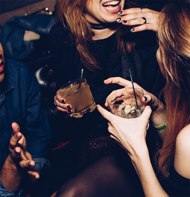 women drinking and laughing at club