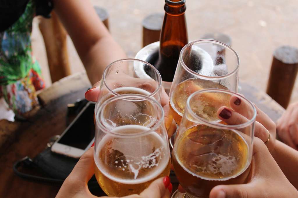 A group raising glasses of alcoholic drinks