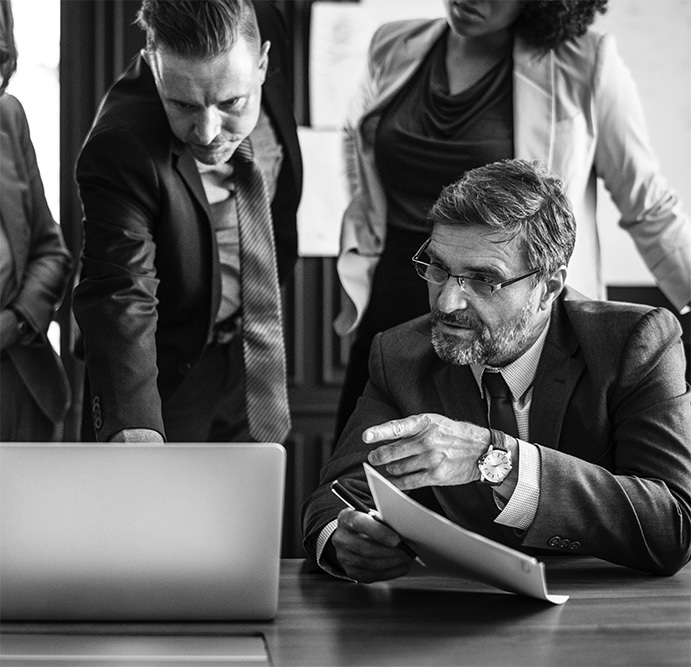 employees talking at a desk