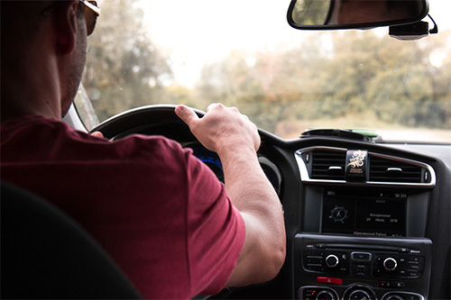 man driving car