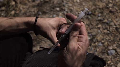 man holding syringe