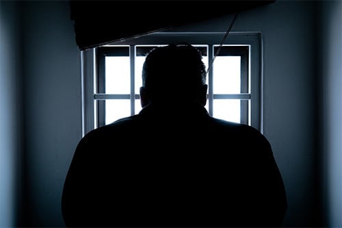 man in prison cell