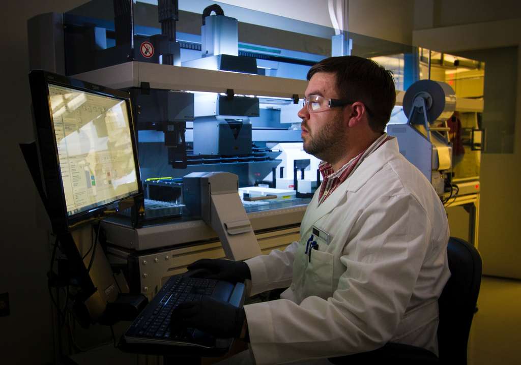 A medical professional in a laboratory viewing test results