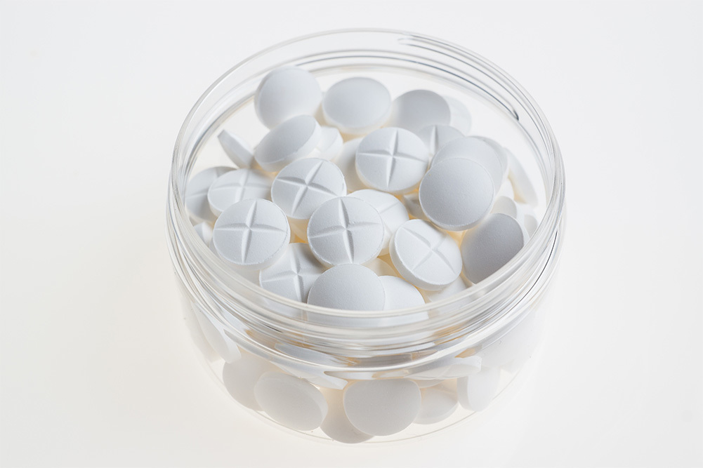white pills in a jar
