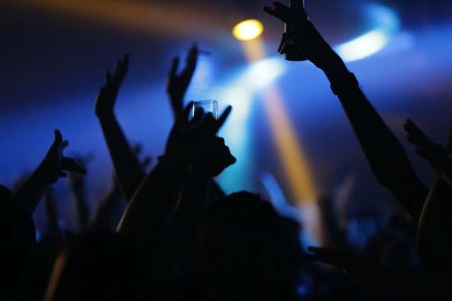 Silhouette of people drinking and smoking in a club