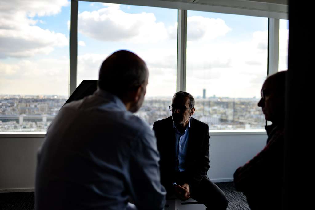 people talking near a window