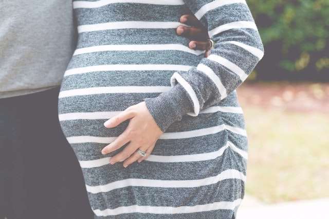 pregnant woman holding belly learning about drug use during pregnancy
