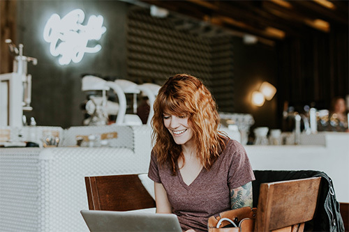 smiling woman working on her laptop