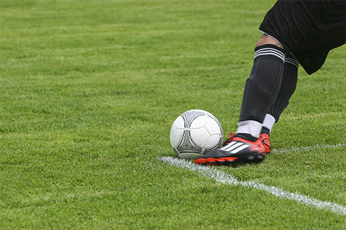 soccer player kicking ball