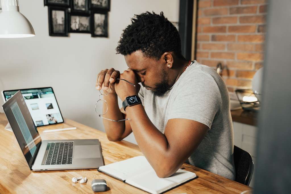 A stressed male employee working remotely