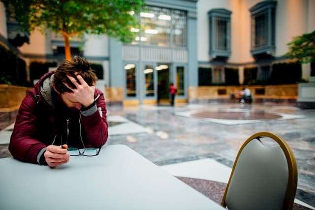 stressed man with head in hands