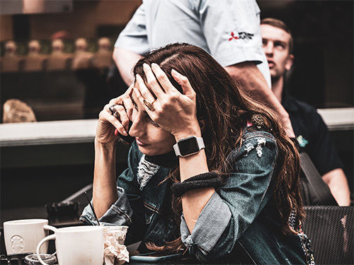 stressed woman with head in hands