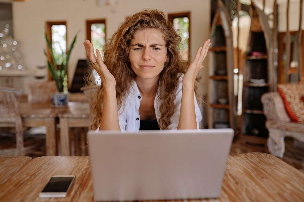 Woman sitting at her laptop stressed out