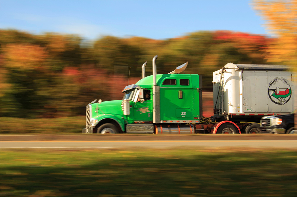 green truck driving on the road