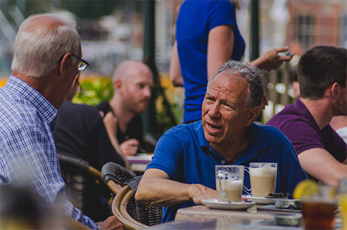 two men talking over coffee