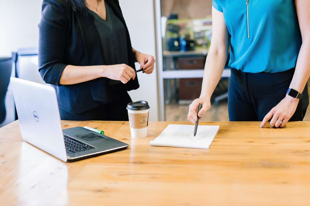 two people standing at a table