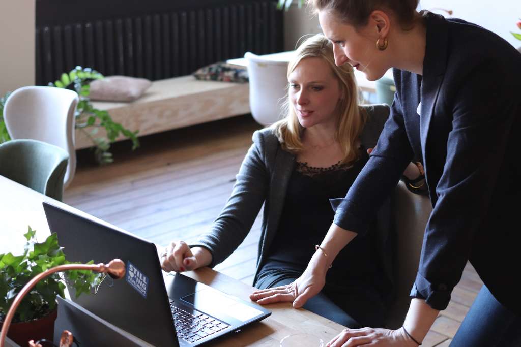 two women looking at a monitor