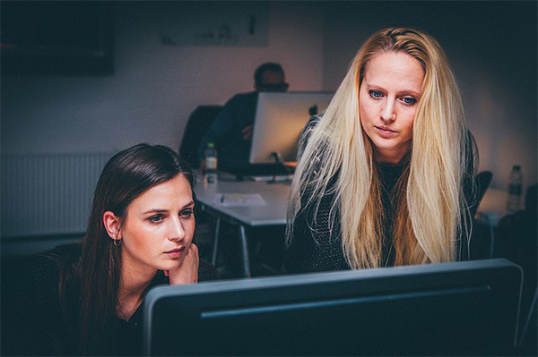 two women working at a computer