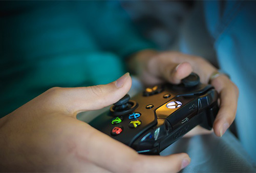 woman holding video game remote control