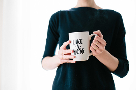 woman holding white mug