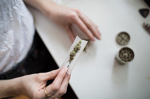 woman rolling joint