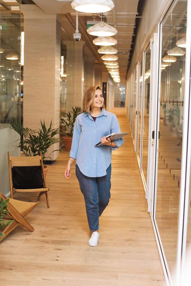 Woman smiling walking through workplace